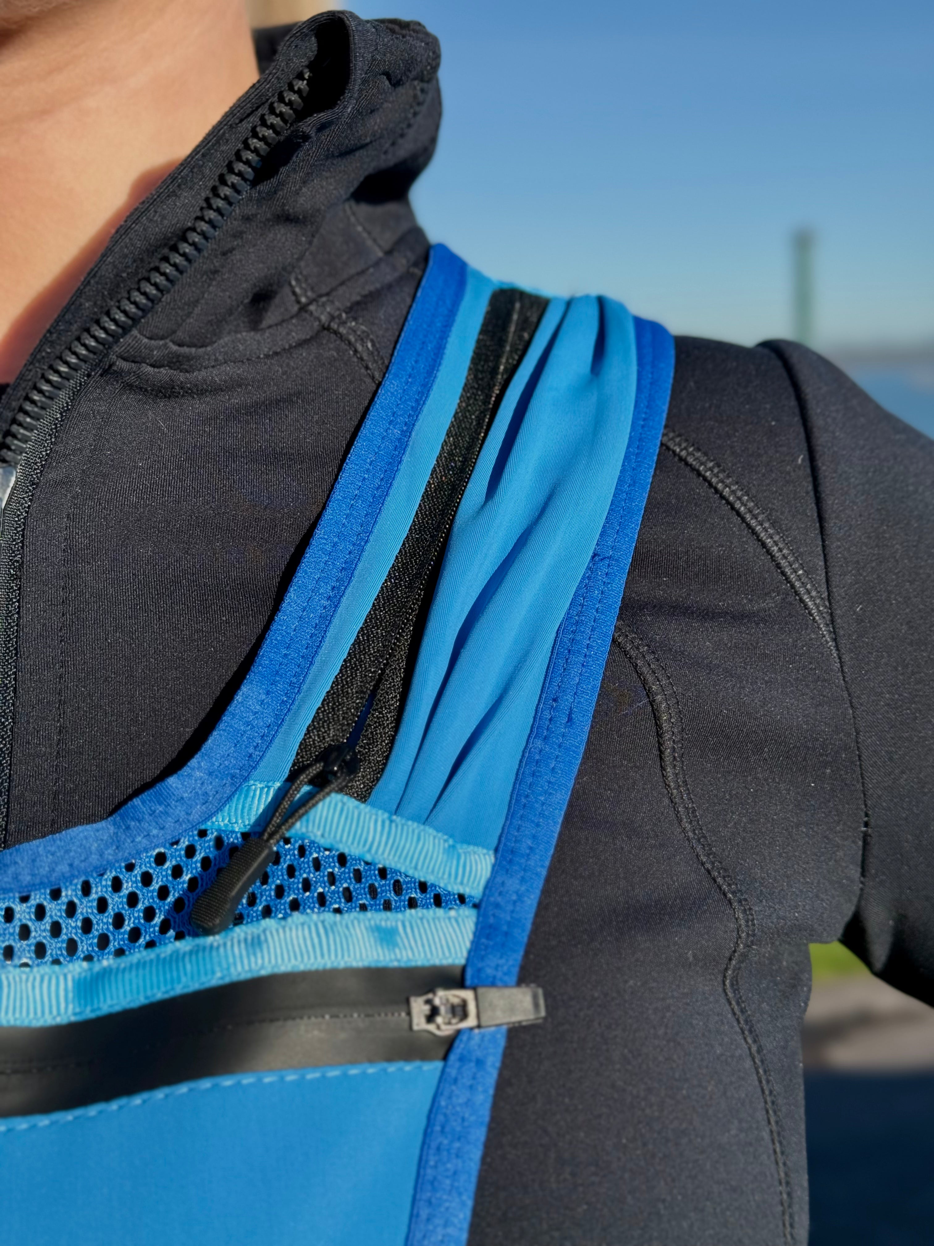A close up image of the blue Eos Elite RainGuard running best shows the strap pocket