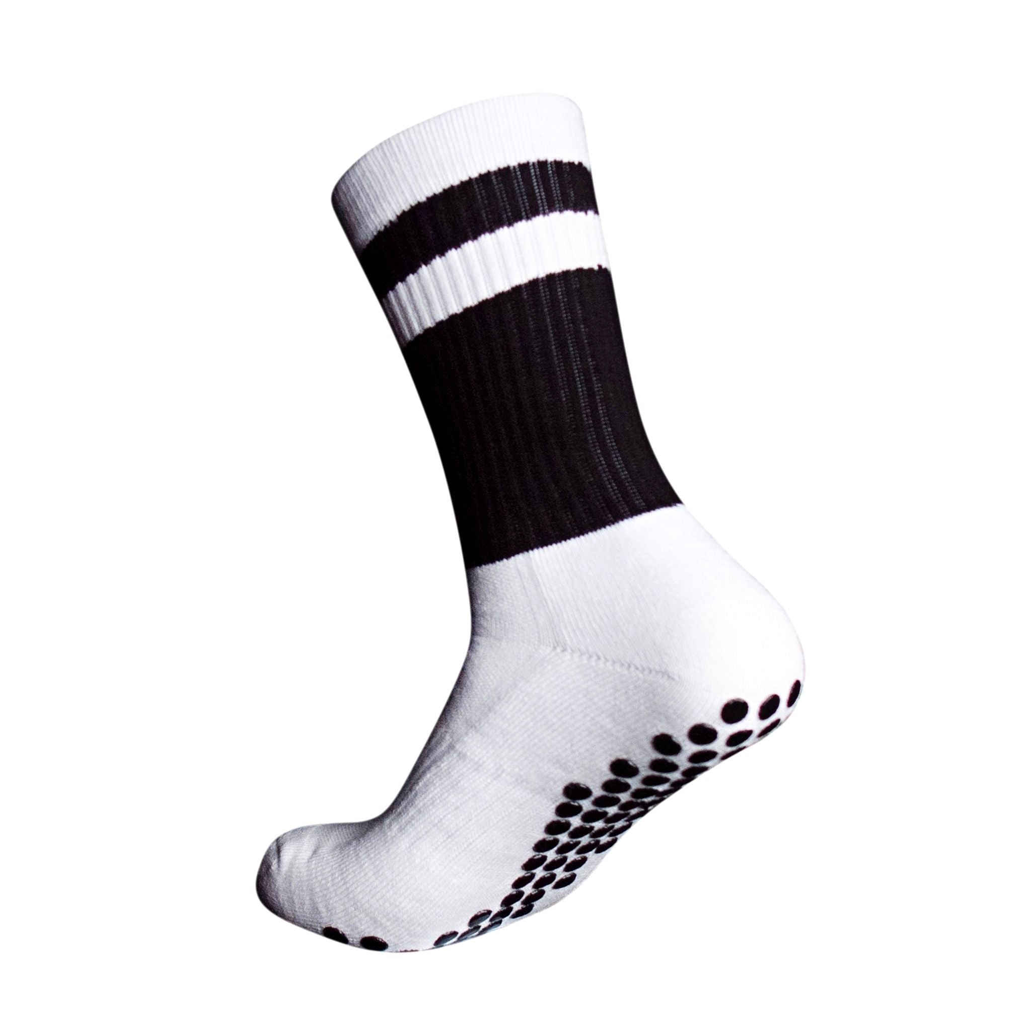 A side profile of an Eos Elite Ultrasoft grip sock in white and black with white stripe clearly shows the elasticated, breathable material and silicon grip pads on the base of the sock.